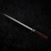 Messermeister Royale Elite Honing Steel, 10 inches, with a fine grit surface and American walnut handle, lies on a dark surface, showcasing its elegant design.