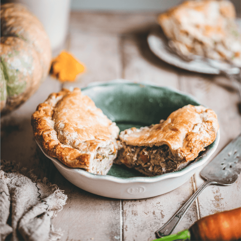 Emile Henry 175th Anniversary Pie Dish displaying a flaky, savory handheld pie with poultry filling, highlighting fine French bakeware craftsmanship.
