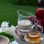 Earth & Nest | Lait Creamer on wooden tray with glass of milk and honey, embodying Athens Cooks' curated kitchenware aesthetic.