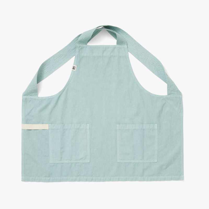 Hedley & Bennett | Smock - Eggshell Blue: Light teal apron with crossback straps, front patch pockets, and utility loop. Crafted from a cotton-linen blend for kitchen comfort.