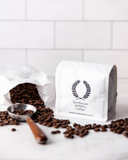 Farmhouse Pottery | Coffee Scoops - Artisan nestled in roasted beans, featuring a scalloped wooden handle and brushed gold finish, ideal for precise coffee measurement.