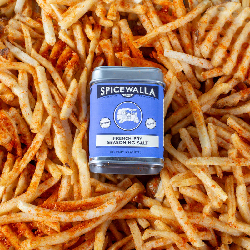 Spicewalla | French Fry Seasoning Salt tin atop seasoned fries, showcasing a zesty, sweet, and spicy blend perfect for enhancing any fry type.