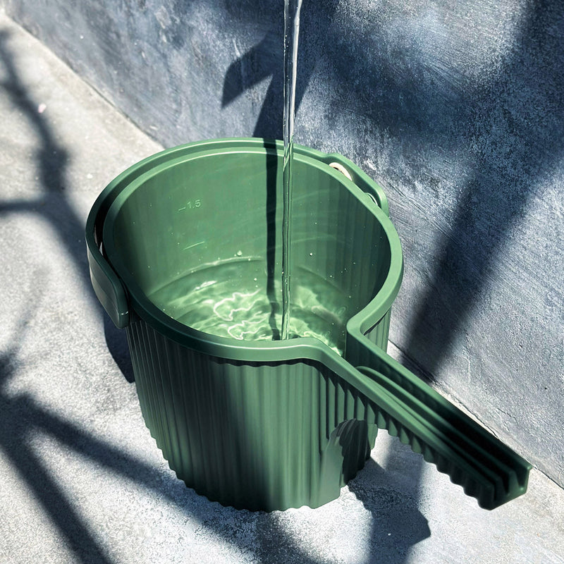 Filling Hachiman Garden Beetle watering can in Garden Green with a hose