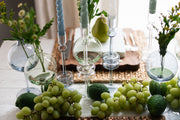 Clear Glass Large Pair Candlestick on a table with fruit and candles, adding elegance and charm to a kitchen or dining setting.