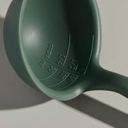 GIR | Ultimate Ladle - Teal: A green plastic ladle with embossed measurements and a precision pouring edge, designed for versatile kitchen use.