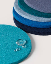 Graf Lantz - Bierfilzl Merino Wool Round Coaster Multi 6 Pack, showcasing stacked blue and grey felt circles with water-resistant surface, ideal for elegant home décor.