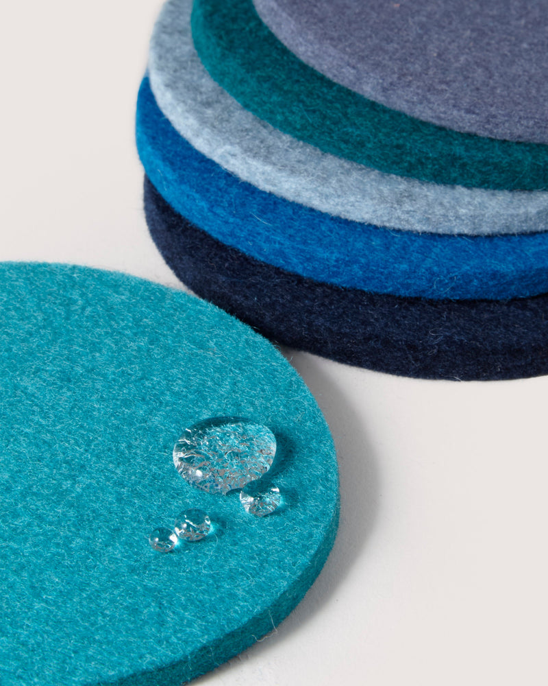 Graf Lantz - Bierfilzl Merino Wool Round Coaster Multi 6 Pack, showcasing stacked blue and grey felt circles with water-resistant surface, ideal for elegant home décor.