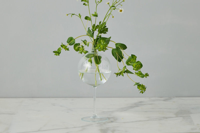 Clear Wine Glass Vase Medium from Etú Home, featuring a unique glass sphere atop a wine glass stem, ideal for elegant table centerpieces and floral arrangements.