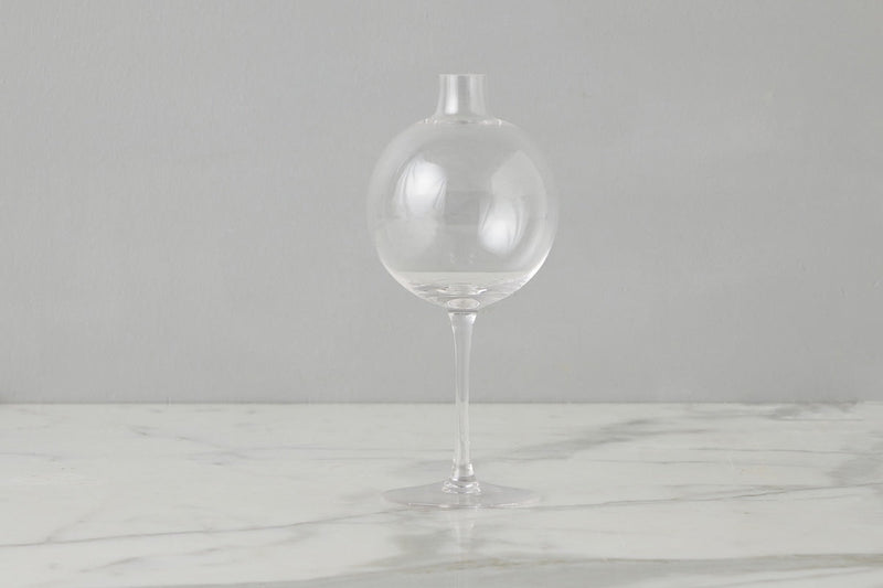 Etú Home | Clear Wine Glass Vase Medium: A unique vase featuring a glass sphere atop a wine glass stem, perfect for elegant table centerpieces and special occasions.