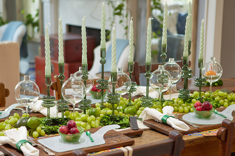 Etú Home | Clear Wine Glass Vase Medium featured as a table centerpiece with grapes and candles, showcasing its elegant design perfect for weddings or dinner parties.