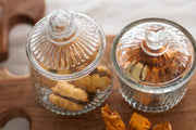 Etú Home's Bistro Bon Bon Jar, inspired by 1930s Depression glass, is a textured glass jar with a lid, ideal for storing snacks or desserts.