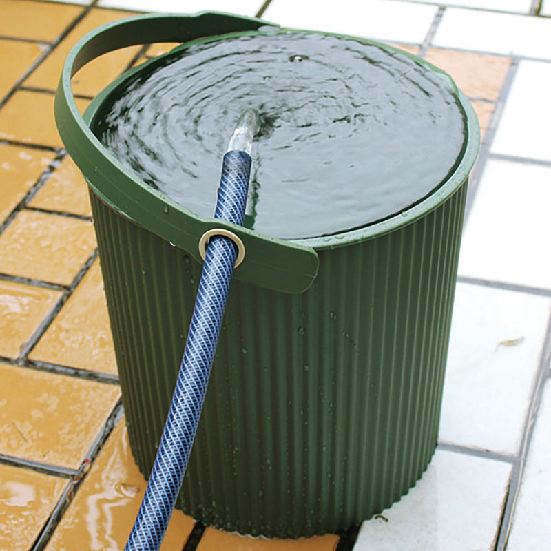 Hachiman | Bucket, Extra Large Garden Green, fills with water via blue hose, showcasing its hands-free design and versatile use for home or garden tasks.