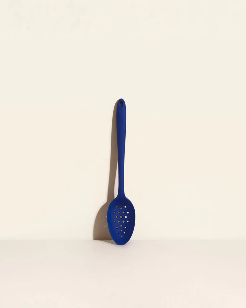 GIR Perforated Spoon: Navy, featuring a branching hole pattern for efficient straining, displayed on a white surface, ideal for cooking and serving.