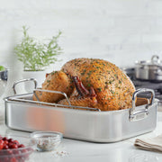 Hestan Provisions Classic Roaster with Rack in stainless steel, showcasing a roasted turkey, herbs, and cranberries on a kitchen counter at Athens Cooks.