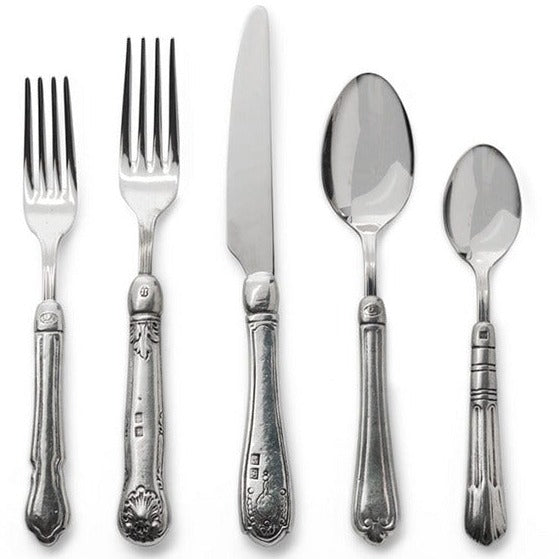 Arte Italica & Crown Linen Designs | Hotel 5-Piece Placesetting showcasing intricately detailed Italian pewter and stainless steel silverware, featuring two forks, a knife, and two spoons.