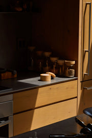 Holcomb Studio | Stash Salt Cellar on a kitchen counter, surrounded by jars of spices and a wooden bowl, ideal for organized seasoning storage.