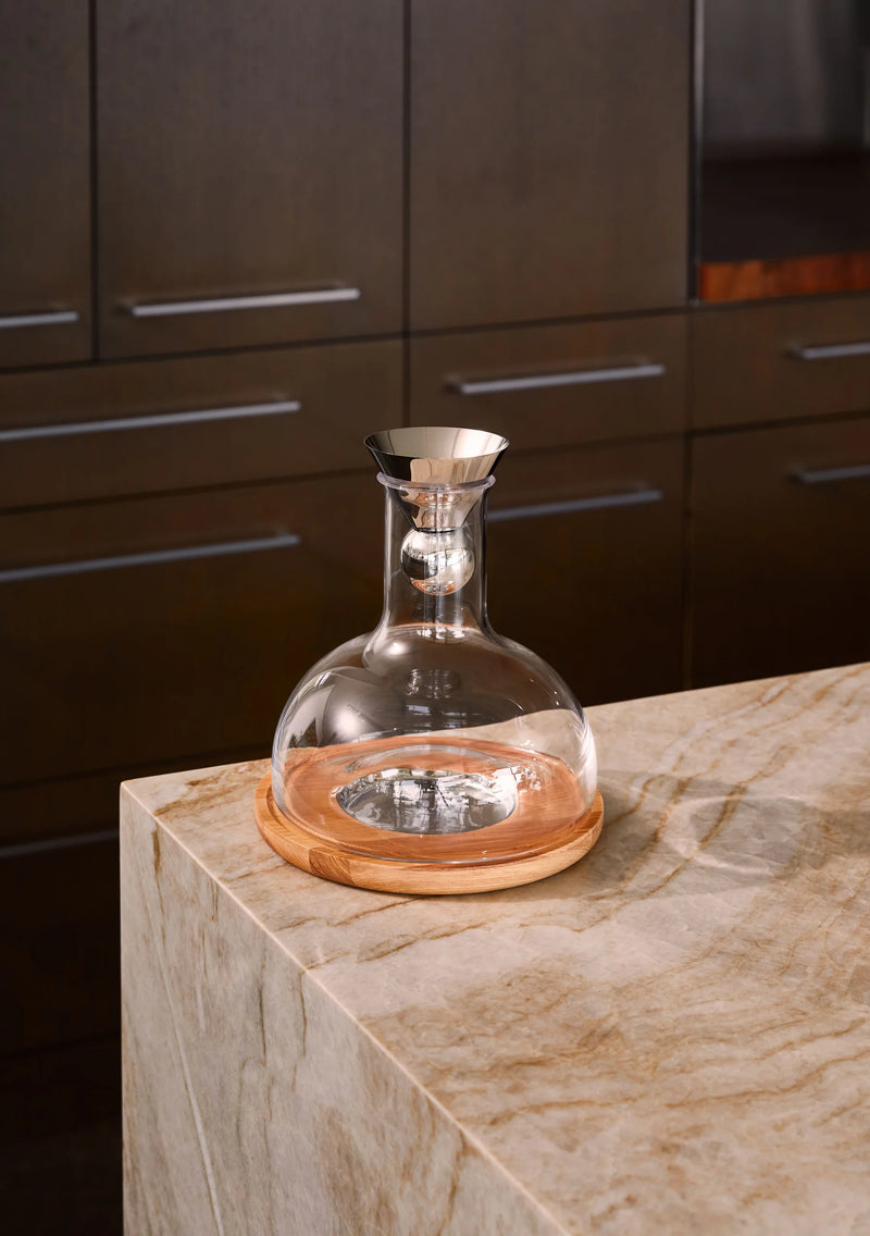 Holcomb Studio | Birdie Wine Decanter, hand-blown glass on ash wood trivet, showcasing aerating sphere for enhanced wine aroma and flavor. Perfect for elegant wine service.