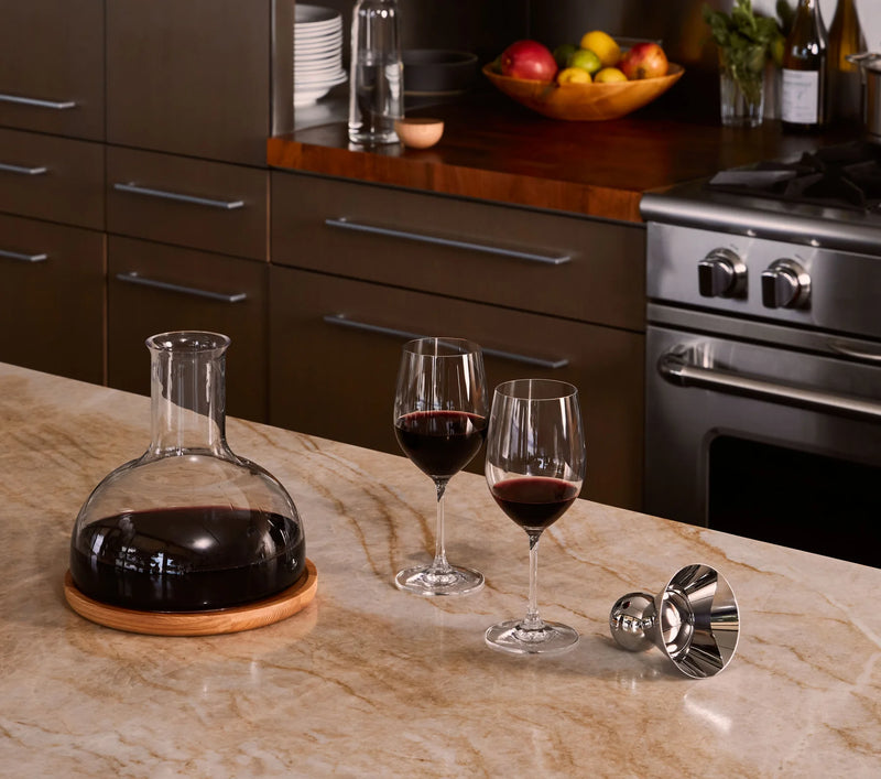 Holcomb Studio | Birdie Wine Decanter with glasses, showcasing its elegant design and aerating function on a kitchen counter.