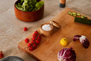 Holcomb Studio | Stash Salt Cellar on a cutting board with vegetables, including lettuce and cherry tomatoes, showcasing a stylish kitchen accessory from Athens Cooks.