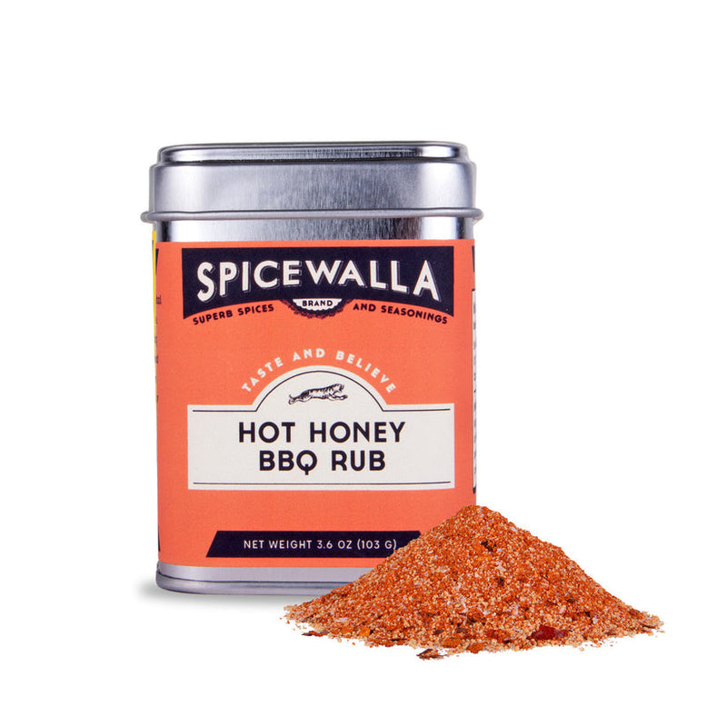 Spicewalla | Hot Honey BBQ Rub tin beside a small spice pile, highlighting its sweet-heat blend for enhancing dishes like fried chicken and pork chops.