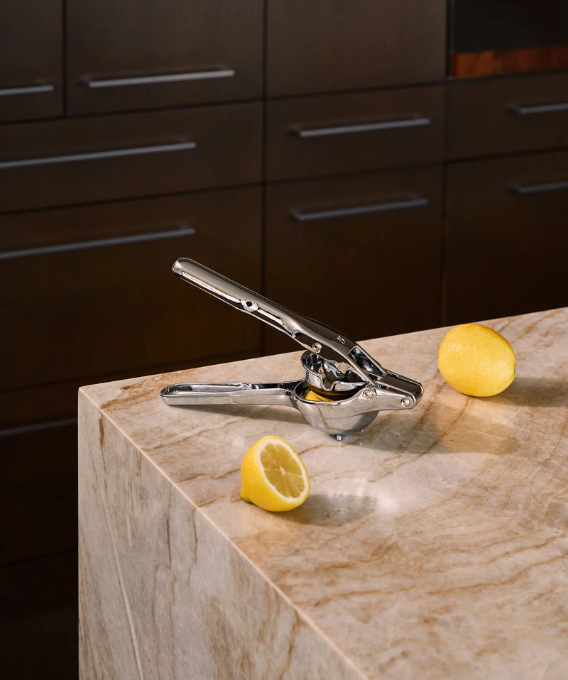 Holcomb Studio | Link Citrus Press on a marble counter with lemons, showcasing its efficient design for juicing, available at Athens Cooks.