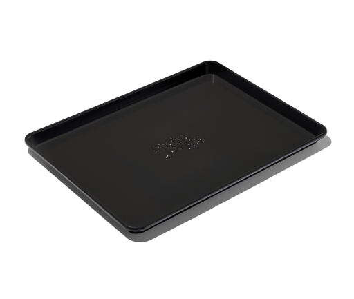 Great Jones | Holy Sheet - Pepper: Close-up of the nonstick ceramic-coated half-sized sheet pan, ideal for easy cleanup and stylish table presentation.