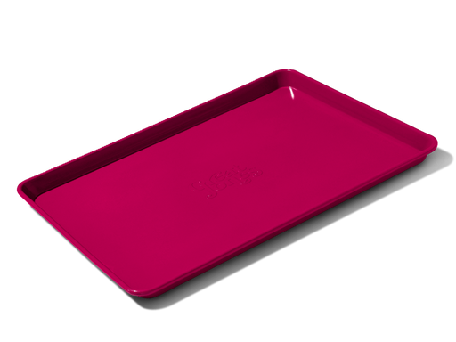 Great Jones | Holy Sheet - Pepper: A versatile half-sized sheet pan with nonstick ceramic coating for easy cleanup, ideal for both baking and serving.