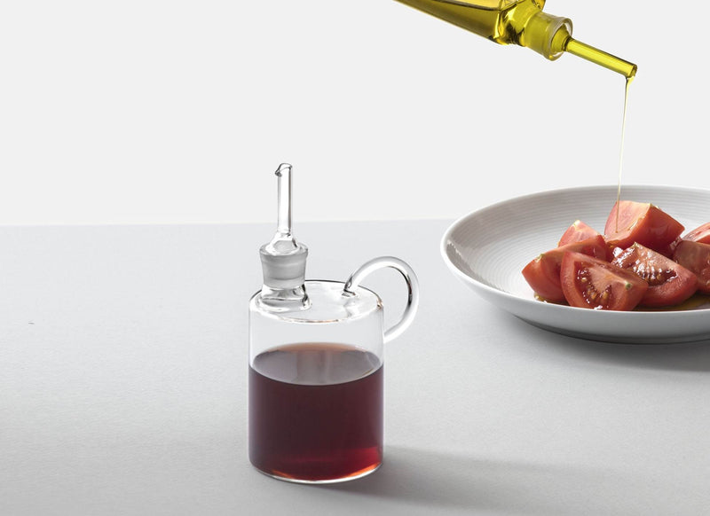 Ichendorf | Tokyo Balsamic Vinegar Bottle, 10.1 oz, elegantly drizzles oil over tomatoes, showcasing its precision pourer. Ideal for Mediterranean-inspired dining.