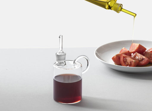 Ichendorf | Tokyo Balsamic Vinegar Bottle, 10.1 oz, elegantly drizzles oil over tomatoes, showcasing its precision pourer. Ideal for Mediterranean-inspired dining.