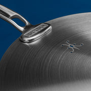 Hestan | Commercial Clad Stainless Steel Universal Lids, 12.5 Inches featuring a polished handle with maker's name and decorative vent pattern for efficient cooking.