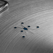 Hestan | Commercial Clad Stainless Steel Universal Lid, 12.5 Inches, showing steam vent holes around a central cutout with a polished handle visible.