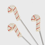 Joanna Buchanan | Cocktail Picks - Candy Cane: Close-up of festive candy cane cocktail picks, perfect for holiday drinks, with red and white designs on stainless steel.