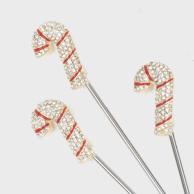 Joanna Buchanan | Cocktail Picks - Candy Cane: Close-up of festive candy cane cocktail picks, perfect for holiday drinks, with red and white designs on stainless steel.