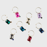 Joanna Buchanan Party Set featuring colorful gemstone cocktail picks and wine charms displayed on a gold hoop, ideal for enhancing barware collections.