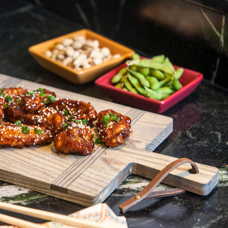 J.K. Adams | 1761 Ash Driftwood Rectangular Serving Board, Small, showcasing crispy fried chicken with sesame seeds and scallions, accompanied by edamame and nuts.