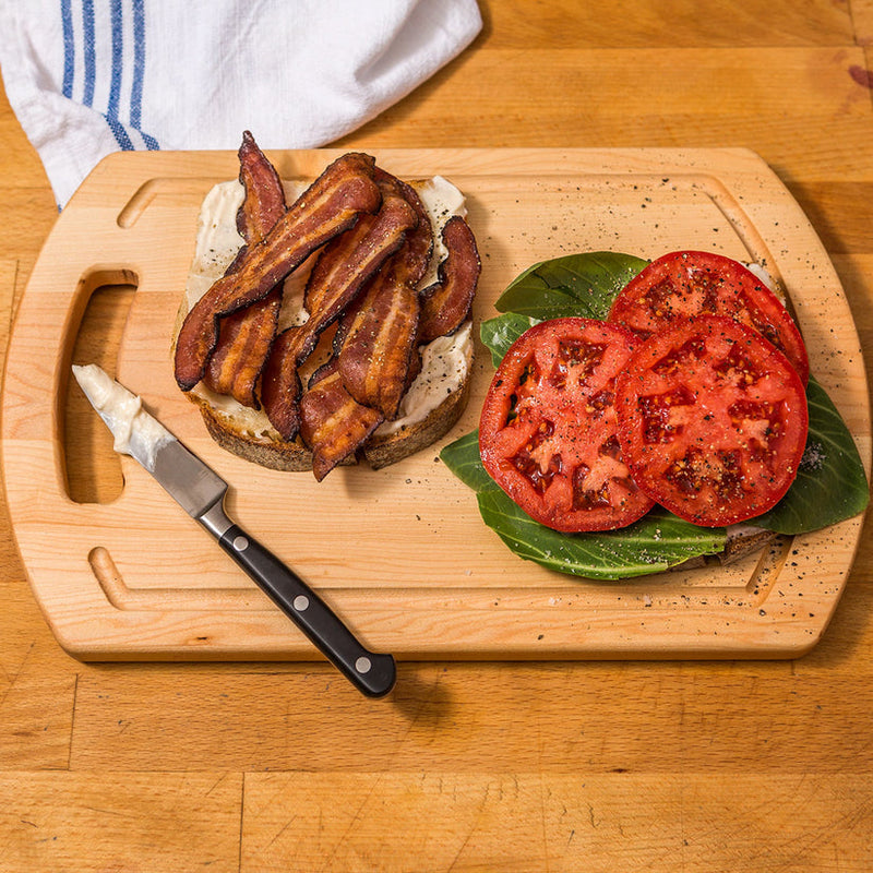 J.K. Adams Maple Everyday Medium Prep Board with two open-faced sandwiches being assembled, showcasing its utility for daily kitchen tasks.