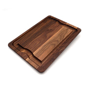 J.K. Adams Walnut BBQ Carving Board with juice grooves and hand grips, ideal for serving and carving meats, enhancing your kitchen experience from Athens Cooks.
