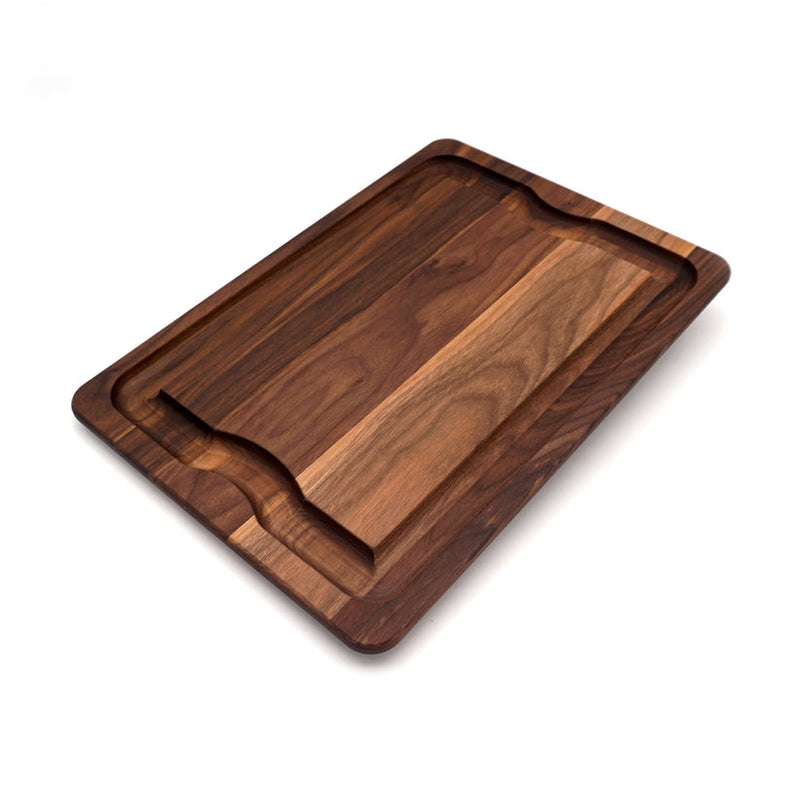 J.K. Adams Walnut BBQ Carving Board with juice grooves and hand grips, ideal for serving and carving meats, enhancing your kitchen experience from Athens Cooks.