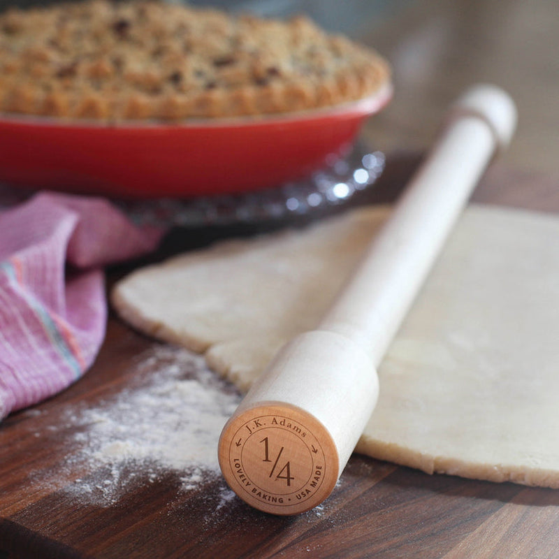 J.K. Adams | Lovely Rolling Pin, 24 Inches, on a floured board with dough, featuring a ¼″ thickness gauge for precise baking results.