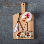 Monogrammed Maple Cheese Board with Letter M, featuring soft cheese with pomegranate arils, crusty bread slices, and a cheese knife, ideal for small gatherings.