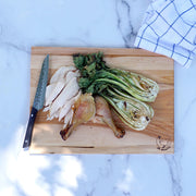 J.K. Adams | Maple Reversible Prep Boards, 16 x 12 inches, displaying chicken and veggies on a marble countertop, with a chef’s knife and checkered towel.