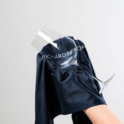 Richard Brendon | Jancis Robinson Original Wine Glass Set of 2, featuring a hand holding one glass, showcasing its tulip-shaped bowl and elegant design.