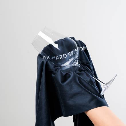 Richard Brendon | Jancis Robinson Original Wine Glass Set of 2, featuring a hand holding one glass, showcasing its tulip-shaped bowl and elegant design.