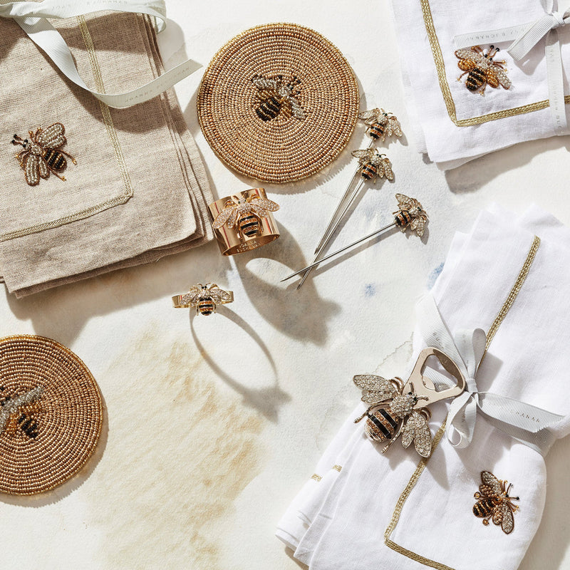 Joanna Buchanan | Bee Cocktail Picks, a set of six whimsical bee-themed picks on a towel, ideal for garnishing drinks, enhancing cocktail presentation.