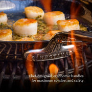 Hestan | Titanium Essential 5-Piece Cookware Set showcasing a seared scallop in a stainless-steel pan with ergonomic handle, emphasizing innovative durability and professional performance.