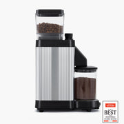 Moccamaster KM5 Burr Grinder with direct-drive motor and stepless adjustment knob for precise coffee grinding, showcased in matte black and polished silver finish.
