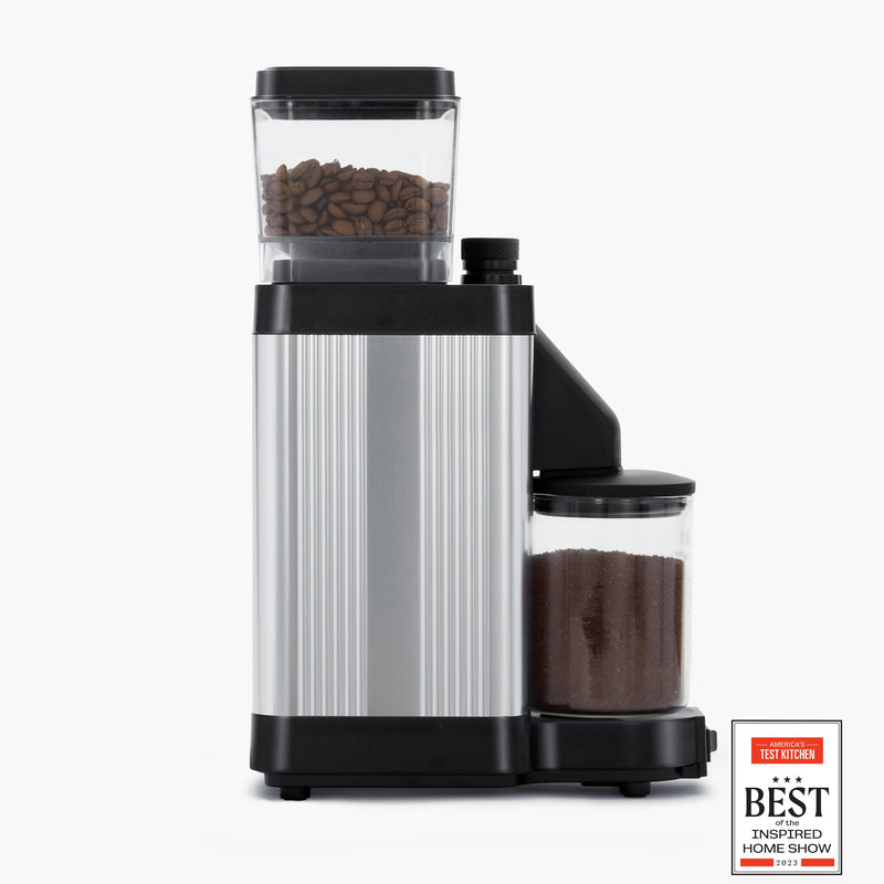 Moccamaster KM5 Burr Grinder with direct-drive motor and stepless adjustment knob for precise coffee grinding, showcased in matte black and polished silver finish.