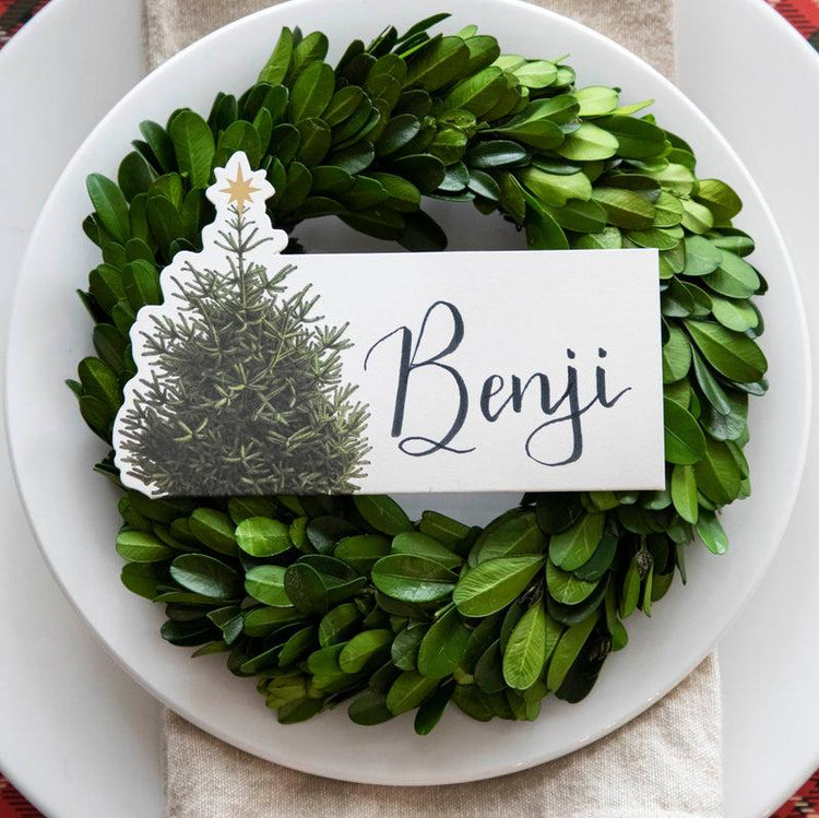 Hester & Cook Christmas Tree Place Card displayed on a plate with a decorative wreath design, showcasing an elegant and festive touch for holiday table settings.