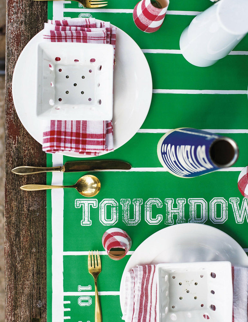 Hester & Cook's Tailgate Collection features a Die Cut Football Place Mat, perfect for enhancing team spirit at any gathering or tailgate celebration.