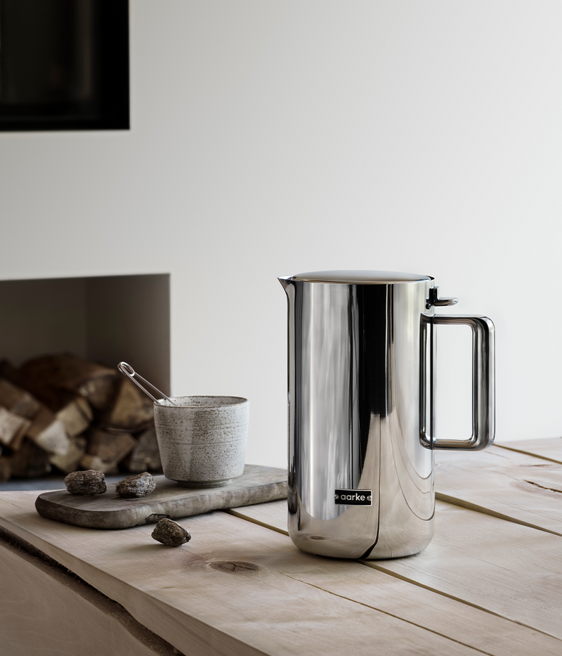 Aarke | Stainless Steel Kettle on wood surface, featuring an elegant design and durable stainless steel construction, ideal for modern kitchens.
